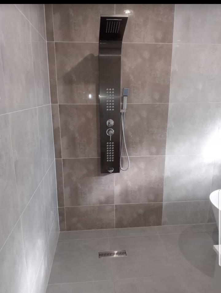 Luxury walk-in shower with stainless steel panel system