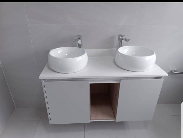 Modern floating vanity with dual vessel sinks and chrome faucets